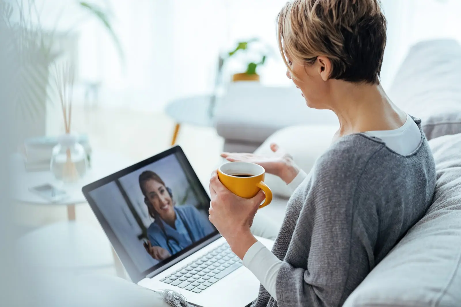 Woman having a video call with her doctor while sitting at home